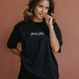 Female model wearing the black "Good Girl" relaxed fit embroidered T-shirt by WNGSPN, styled with understated confidence.