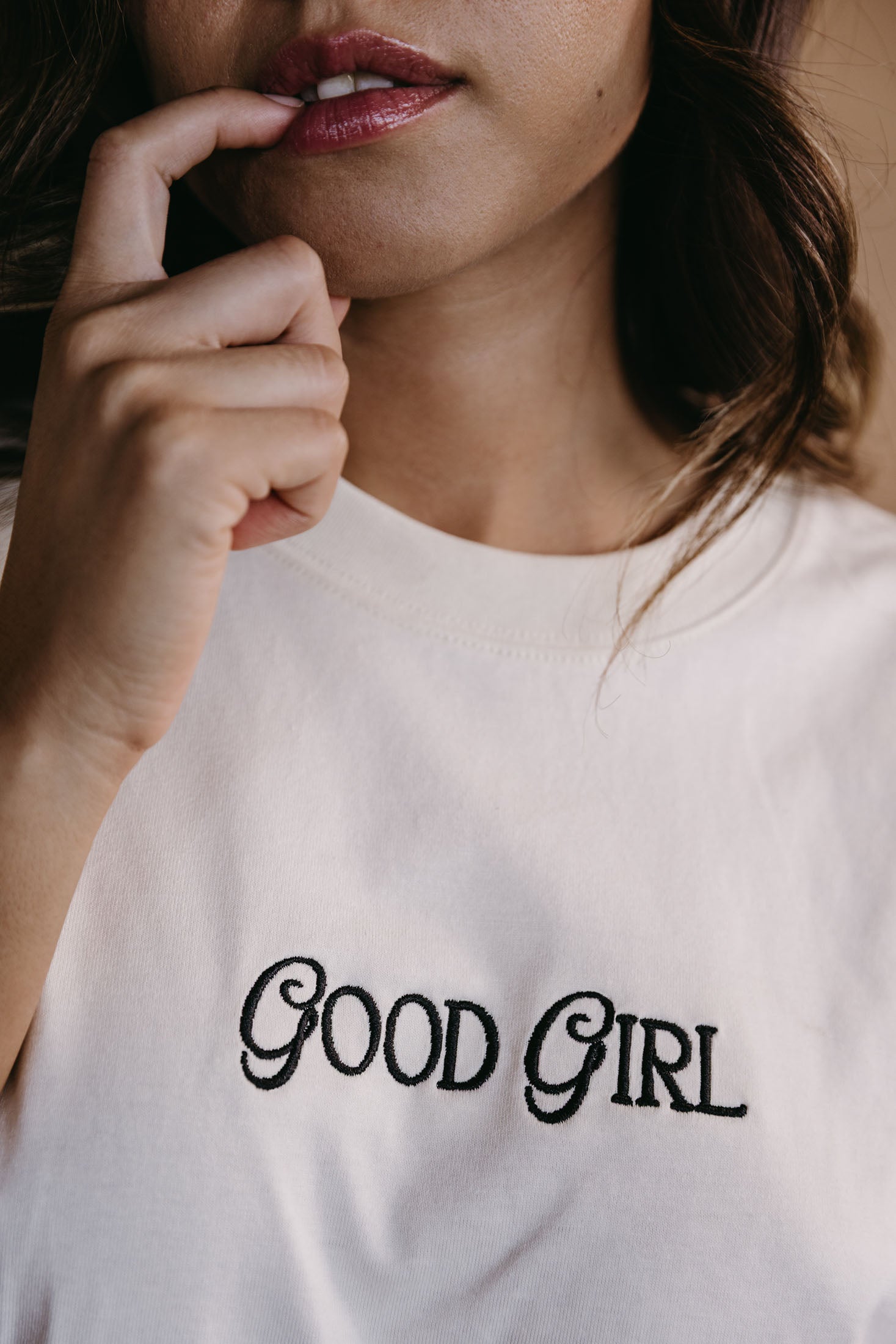 Close-up embroidery detail of the "Good Girl" relaxed fit T-shirt by WNGSPN, highlighting clean, minimalist embroidery.
