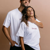 Couple wearing the white "Good Girl" relaxed fit embroidered T-shirt by WNGSPN, with subtle tension and modern edge.