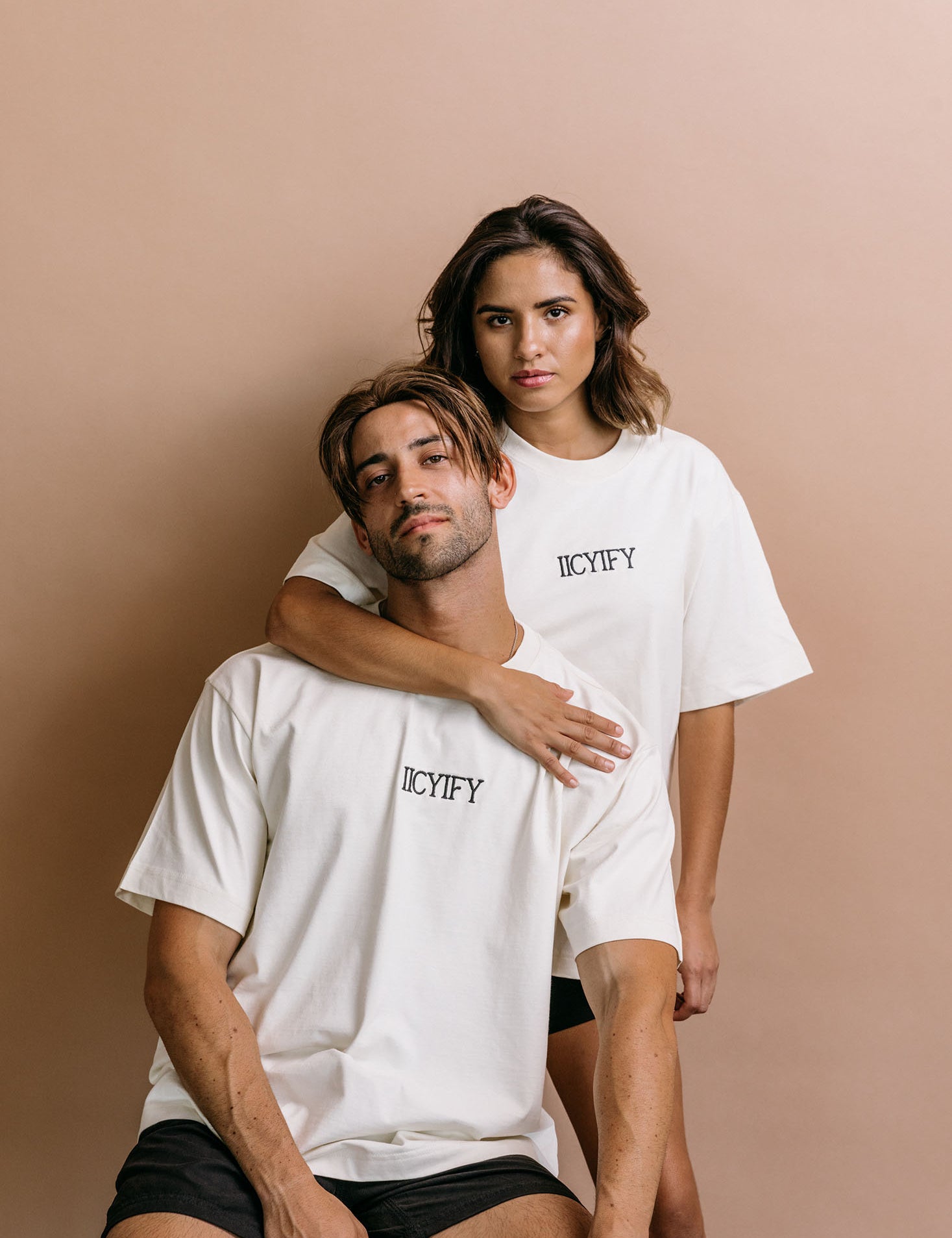 Couple wearing the ecru "Iicyify" relaxed fit embroidered T-shirt by WNGSPN, capturing a refined bookish aesthetic.