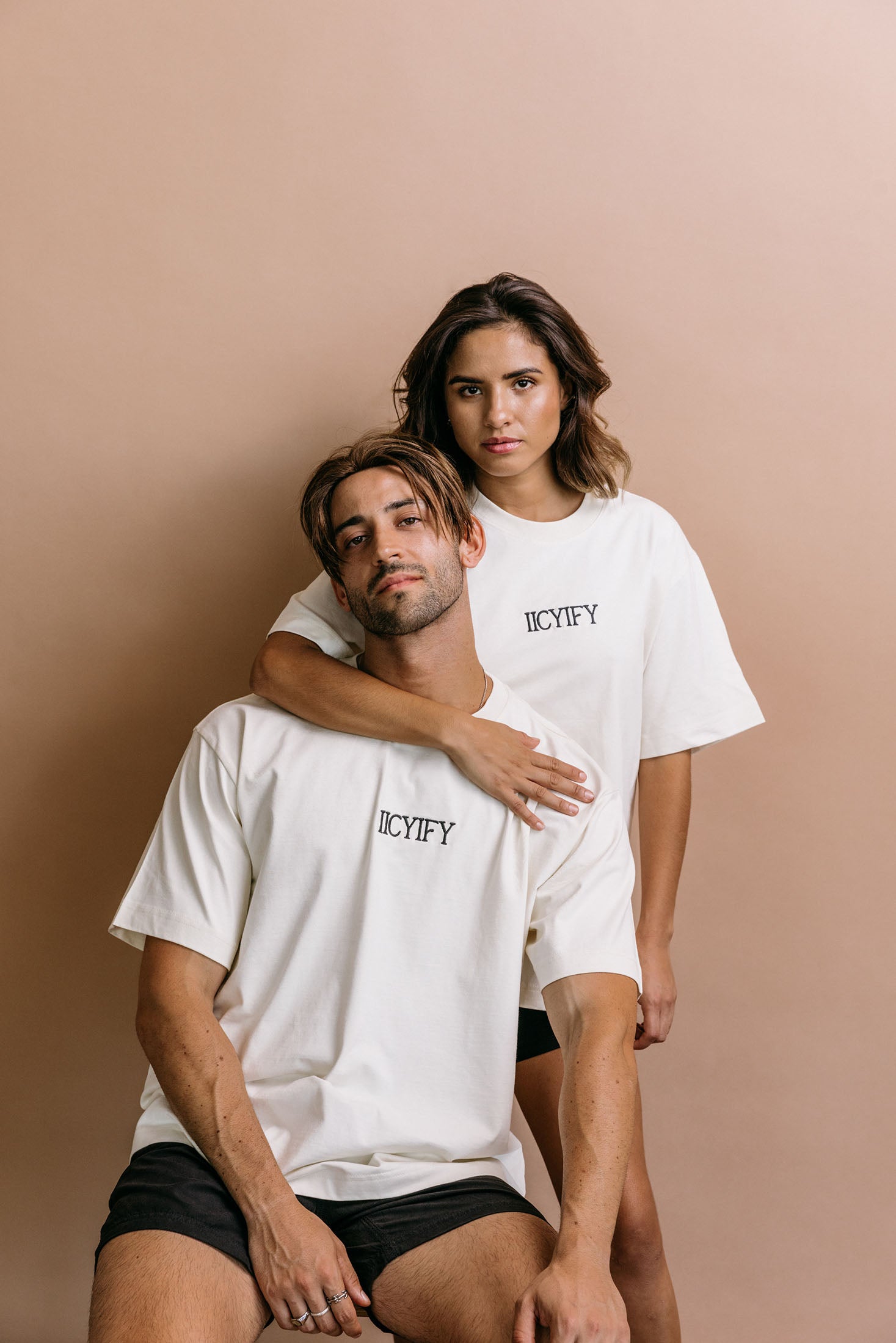 Couple wearing the ecru "Iicyify" relaxed fit embroidered T-shirt by WNGSPN, capturing a refined bookish aesthetic.