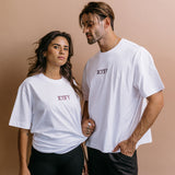 Couple wearing the white "Iicyify" relaxed fit embroidered T-shirt by WNGSPN, with subtle tension and modern edge.