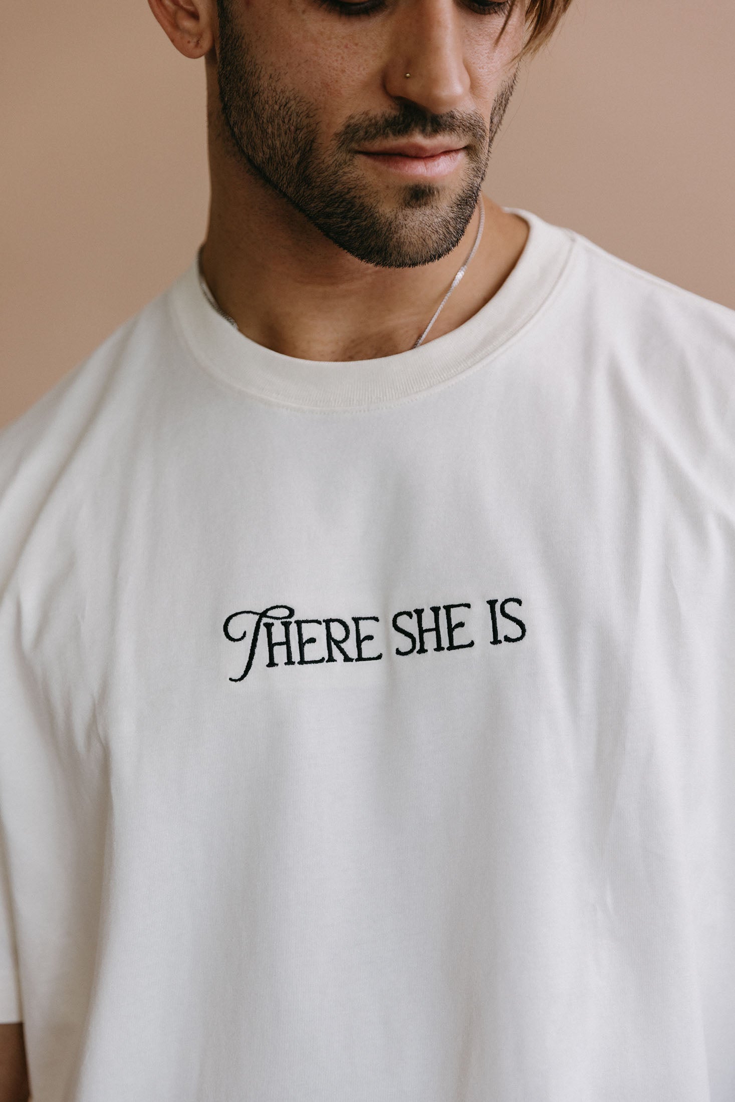 Close-up embroidery detail of the "There She Is" relaxed fit T-shirt by WNGSPN, highlighting clean, minimalist embroidery.