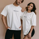 Couple wearing the ecru "There She Is" relaxed fit embroidered T-shirt by WNGSPN, capturing a refined bookish aesthetic.