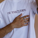 Close-up embroidery detail of the "Use Your Words" relaxed fit T-shirt by WNGSPN, highlighting clean, minimalist embroidery.