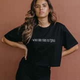 Female model wearing the black "Who Did This To You" cropped embroidered T-shirt by WNGSPN, with a relaxed silhouette and clean lines.