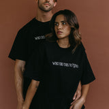 Couple wearing the black "Who Did This To You" relaxed fit embroidered T-shirt by WNGSPN, styled as elevated romance reader apparel.