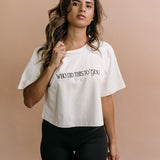 Female model wearing the ecru "Who Did This To You" cropped embroidered T-shirt by WNGSPN, with a relaxed silhouette and clean lines.