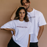 Couple wearing the white "Who Did This To You" relaxed fit embroidered T-shirt by WNGSPN, with subtle tension and modern edge.